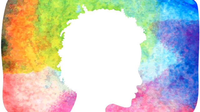 Silhouette of a woman's profile in front of a multi-colored abstract watercolor painting.